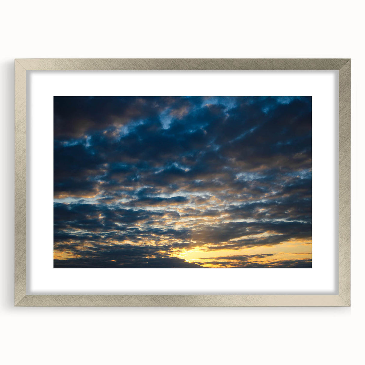 Framed wall art featuring a serene landscape scene with soft colors, silver matting, and a sleek modern frame, perfect for enhancing home decor.