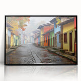 Framed acrylic wall art showcasing a modern street landscape design, featuring vibrant colors and intricate details, presented in a sleek black frame for a contemporary decor accent.