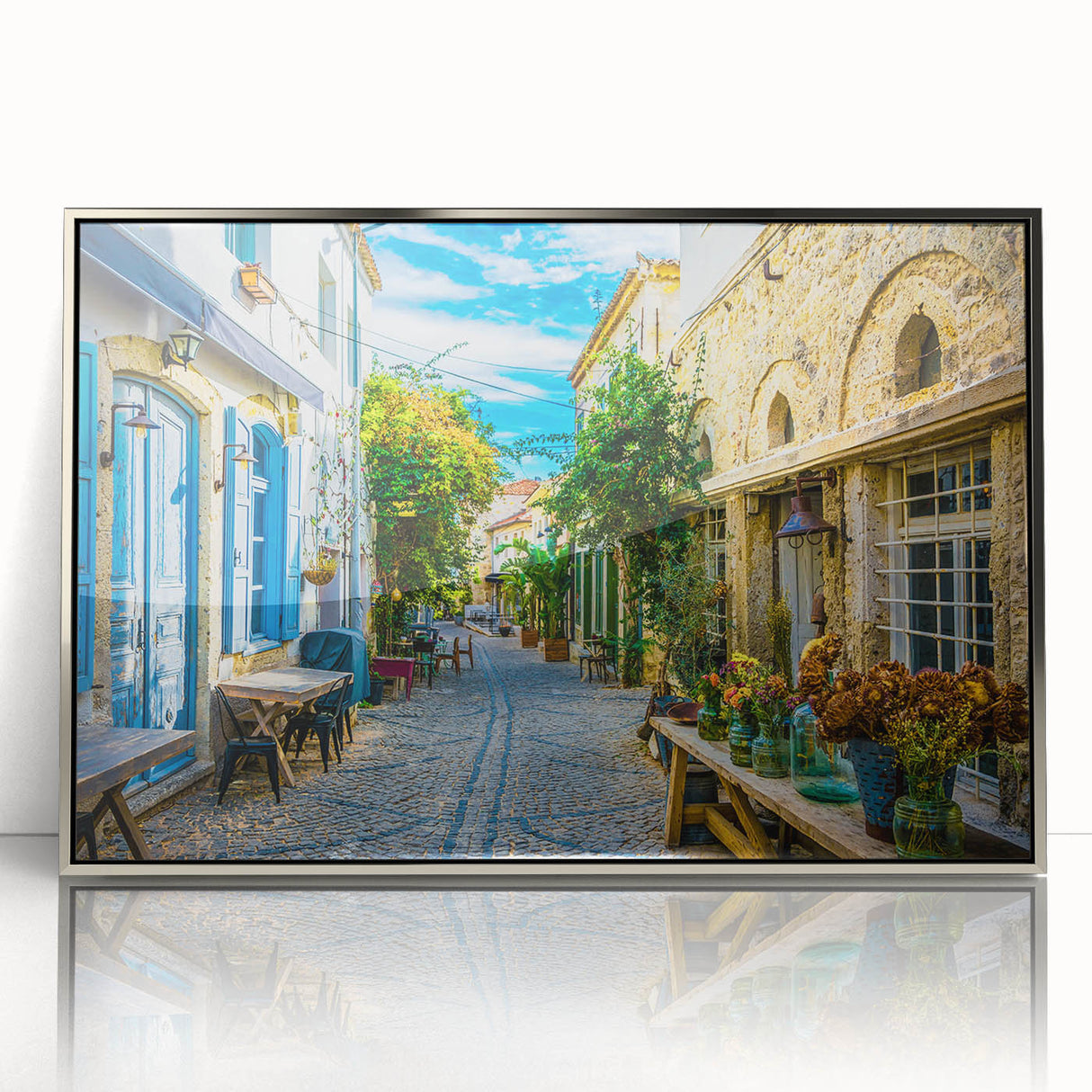 Framed wall art featuring a modern landscape design with vibrant colors and intricate street scenes, set in a sleek silver frame, perfect for home décor.