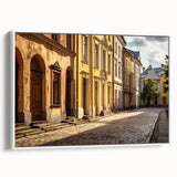 Framed canvas artwork showcasing a contemporary street landscape design in vibrant colors, displayed against a white wall for an elegant home decor accent.