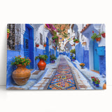 Stretched canvas wall art featuring an abstract urban landscape design in vibrant colors, leaning against a neutral wall, adding a modern artistic touch to interior decor. This piece is perfect for enhancing contemporary living spaces with its dynamic composition and striking hues.