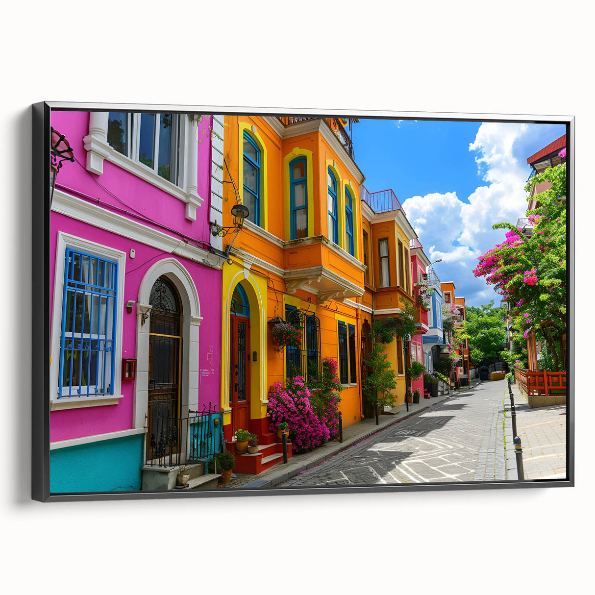 Framed canvas wall art of a city street landscape design showcasing vibrant colors and intricate details, displayed from a side view with a sleek black frame. Perfect for modern home decor, this artwork adds an urban touch to any living space.