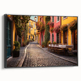 Framed canvas wall art showcasing a vibrant street landscape design, featuring rich colors and intricate details, set against a sleek black frame, perfect for modern decor.