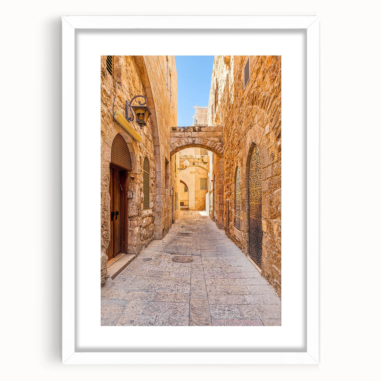 Framed wall art design showcasing a vibrant city landscape with colorful buildings and streets, presented in a sleek white frame with a mat, ideal for modern decor.