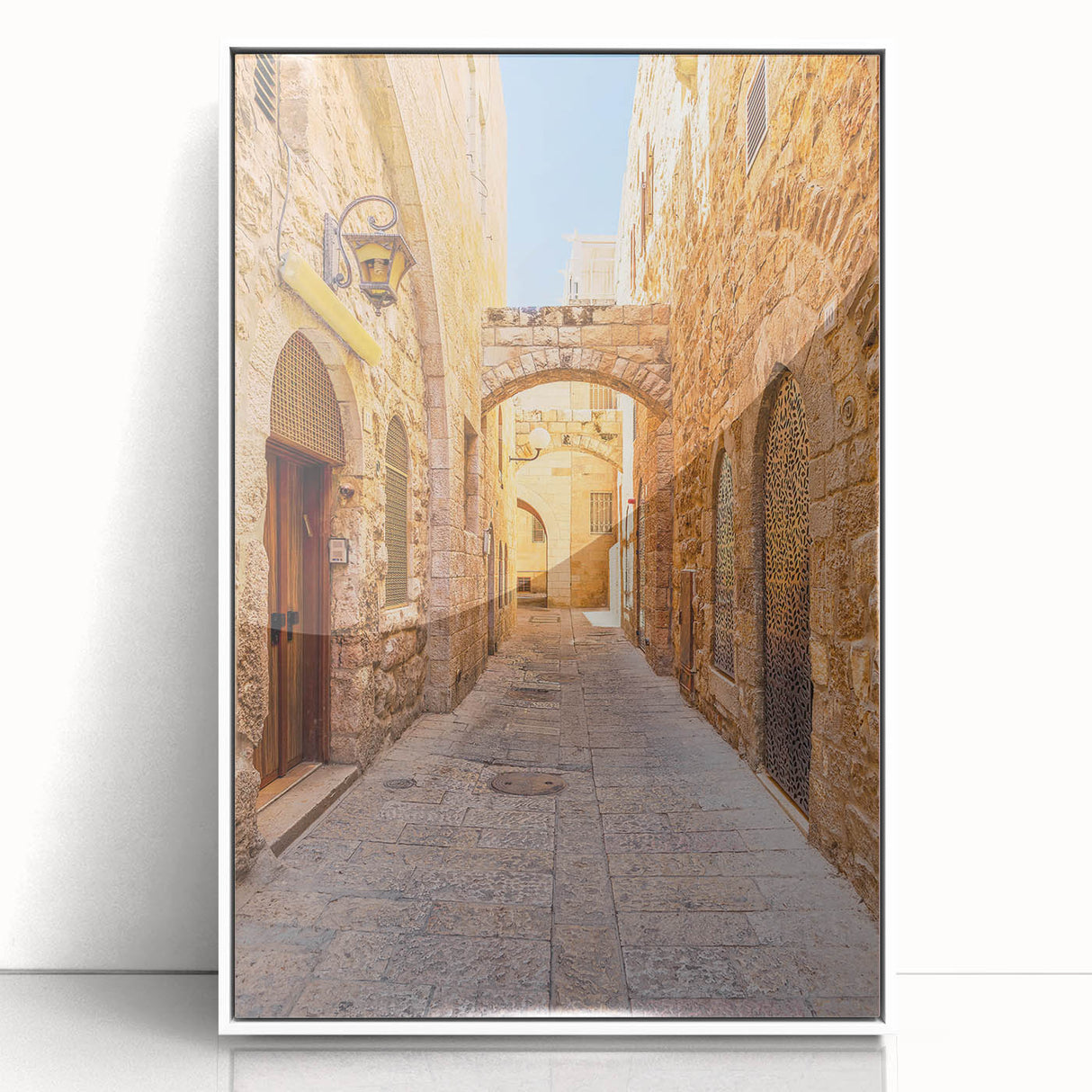 Framed acrylic wall art depicting a vibrant urban landscape with colorful street designs, showcased in a sleek white frame for modern decor.