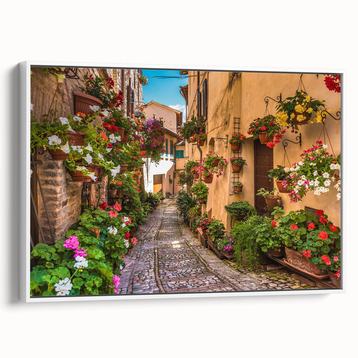 Framed canvas wall art showcasing a vibrant landscape design, featuring lush greenery and a serene street scene with a white frame, perfect for modern decor.