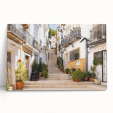 Stretched canvas wall art featuring a vibrant landscape design with colorful streets and abstract elements, leaning against a neutral wall in a modern setting.