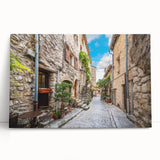 Stretched canvas wall art collection showcasing a vibrant landscape design, featuring a mix of green and blue hues, elegantly leaning against a neutral wall, perfect for modern decor.