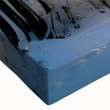 Close-up of a stretched canvas wall art featuring a vibrant landscape design with lush green trees and a serene blue sky, perfect for home decor.