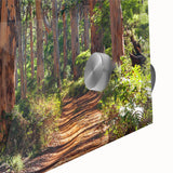 Close-up of an acrylic glass wall art piece depicting a vibrant landscape with lush green trees and a serene atmosphere, ideal for modern home decor.