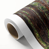 Rolled canvas art featuring a vibrant landscape design with lush green trees and a colorful sky, ideal for home decor. Packaged securely in a cardboard tube for protection during shipping.