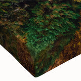 Close-up of a stretched canvas wall art featuring a vibrant landscape design with lush green trees and a serene sky, ideal for home decor.