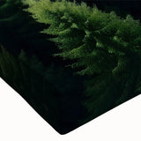 Close-up of a stretched canvas wall art piece featuring a vibrant landscape design with lush green trees and a serene blue sky, ideal for modern home decor.