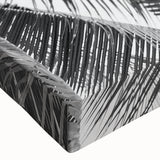 Close-up of a stretched canvas wall art piece featuring a serene landscape design with vibrant green trees and a soft blue sky, ideal for home decor.