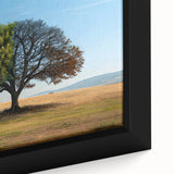 Framed canvas wall art showcasing a close-up of a vibrant landscape design featuring lush green trees and a serene blue sky, perfect for home decor.