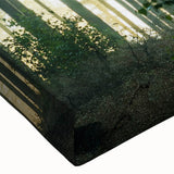 Close-up of a vibrant stretched canvas wall art piece showcasing a detailed landscape design with lush green trees and a serene atmosphere, perfect for home decor.