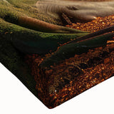 Close-up of a vibrant stretched canvas wall art featuring a lush green landscape with towering trees, ideal for home decor, evoking tranquility and nature's beauty.