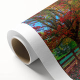 Vibrant rolled canvas artwork showcasing a serene landscape design with lush green trees and a clear blue sky, perfect for enhancing home decor aesthetics.