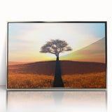 Framed wall art featuring a serene landscape design with trees, set in a sleek silver frame, ideal for home decor and enhancing interior ambiance.