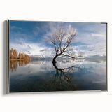 Framed canvas wall art showcasing a serene landscape with vibrant trees in hues of green and gold, complemented by a sleek silver frame, ideal for modern home decor.