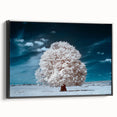 Framed canvas wall art showcasing a serene landscape with vibrant green trees, designed to enhance home decor, viewed from the side against a neutral background.