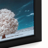 Framed canvas wall art showcasing a vibrant landscape design with lush green trees and a serene blue sky, perfect for home decor. The piece emphasizes nature's beauty.