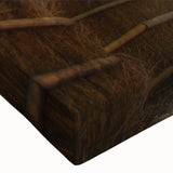 Close-up of a stretched canvas wall art piece showcasing a vibrant landscape with lush green trees, perfect for adding an artistic touch to home decor.