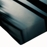 Close-up of a stretched canvas artwork showcasing a vibrant landscape with lush green trees and a serene blue sky, ideal for home decor and nature enthusiasts.