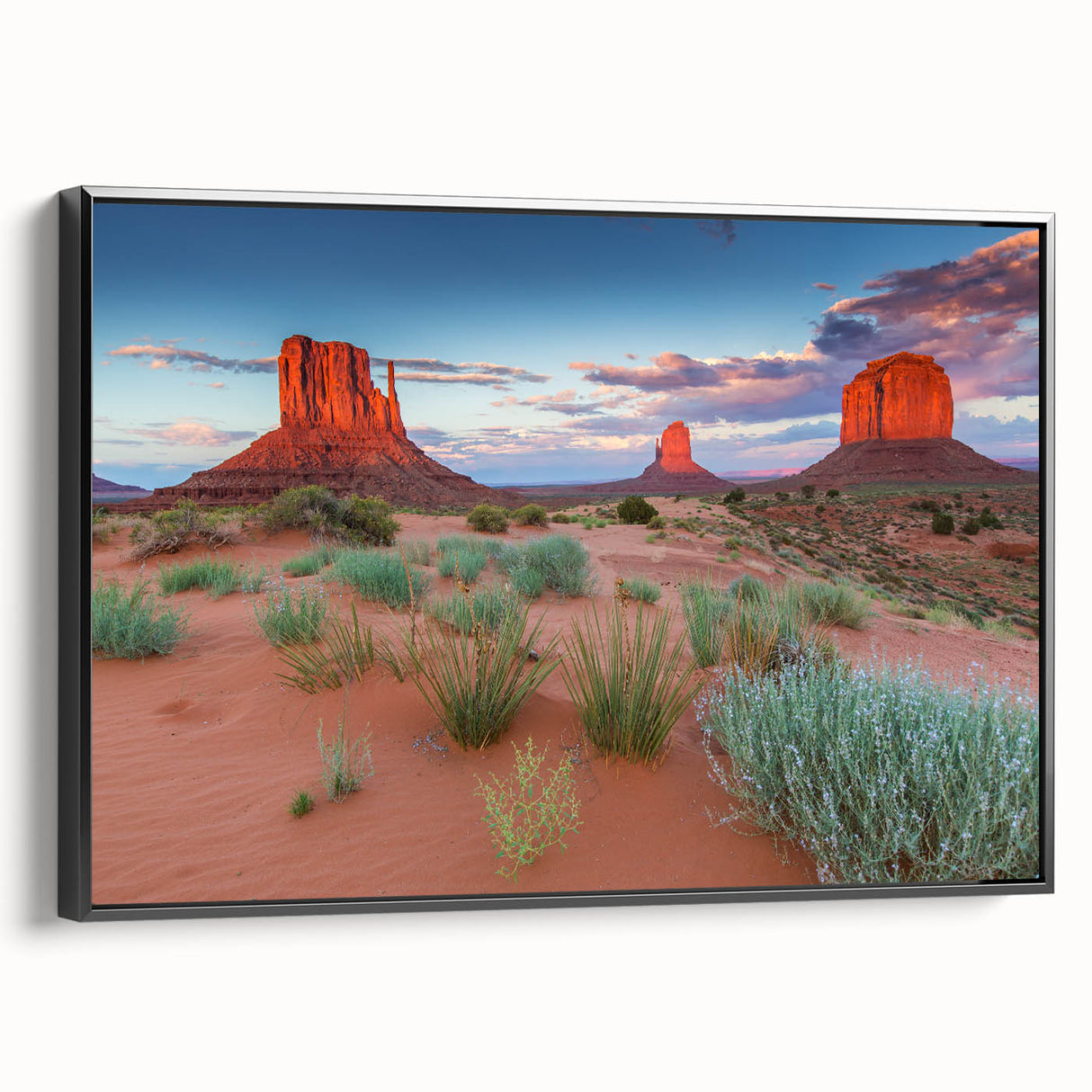 Framed canvas wall art showcasing a serene valley landscape design with rich green hues and textured details, displayed in a sleek black frame from a side view.