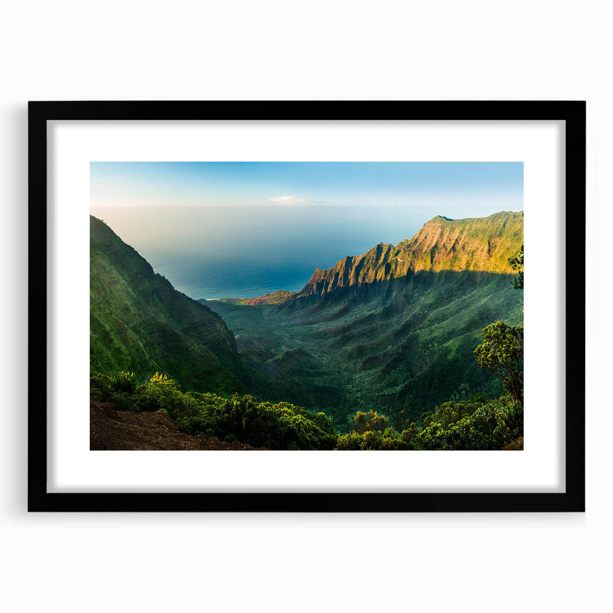 Framed landscape wall art displaying a serene valley scene with rich green hues and a black mat, perfect for enhancing home decor aesthetics.