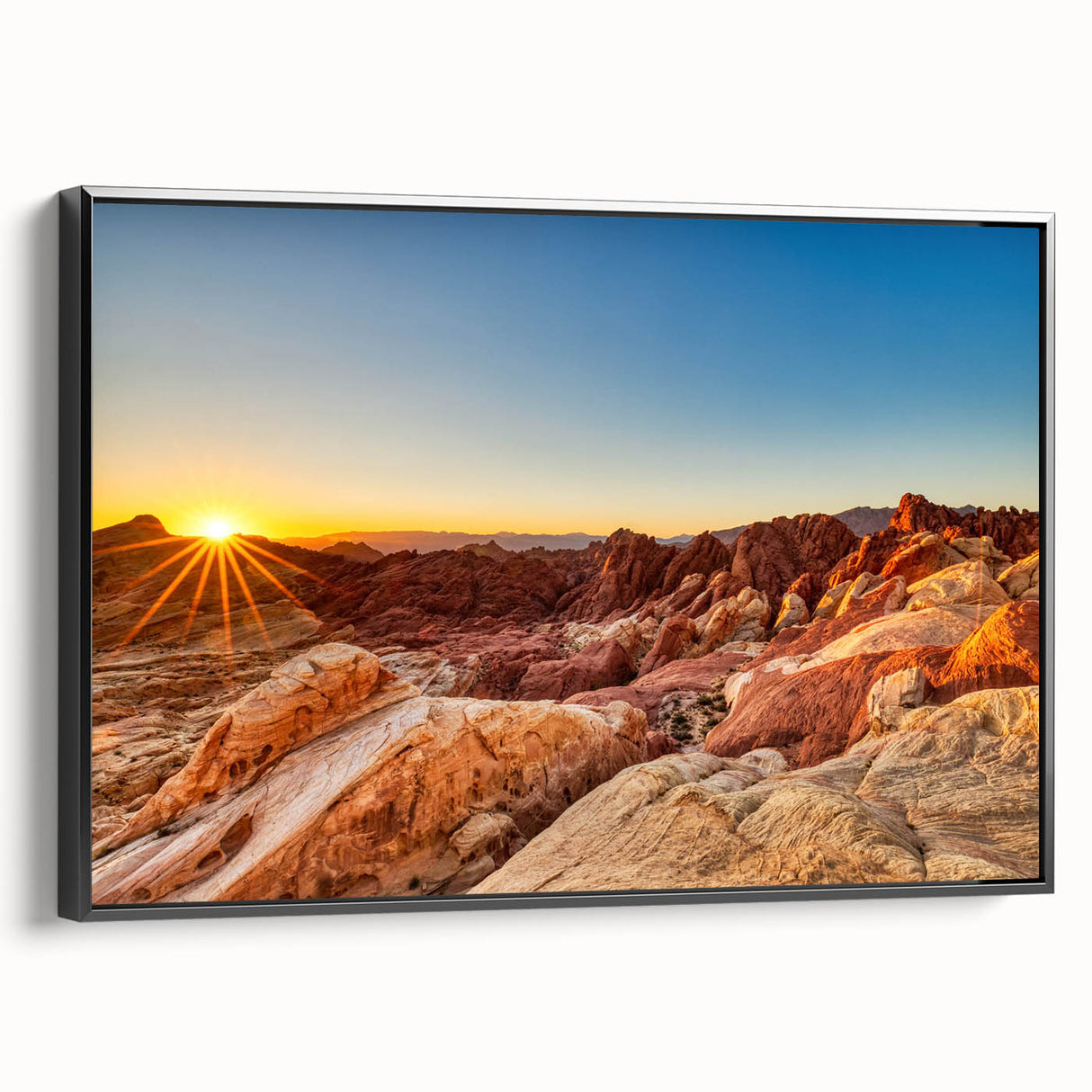 Framed canvas wall art depicting a serene valley landscape with rich green hues and dramatic mountain silhouettes. The artwork features a sleek black frame, enhancing its modern aesthetic. Perfect for adding a touch of nature to contemporary home decor.