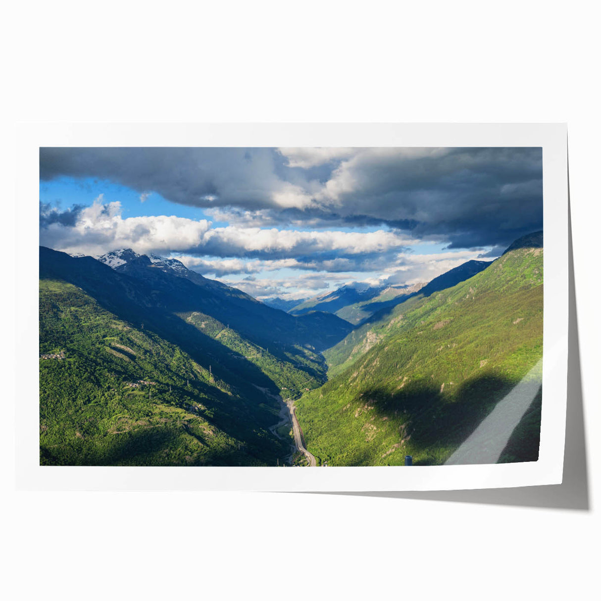 Vibrant rolled print of a serene valley landscape, showcasing lush greenery and distant mountains, perfect for enhancing home decor with nature-inspired art.