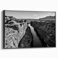 Framed canvas wall art collection showcasing a serene valley landscape design in vibrant colors, with a sleek black frame and side profile view, perfect for home decor.