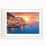 Framed wall art showcasing a serene village landscape design with vibrant colors, set in a white mat and sleek frame, ideal for home decor enhancement.