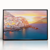 Framed acrylic wall art showcasing a vibrant landscape with colorful village scenes, featuring a sleek black frame and clear front view, perfect for home decor.