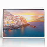 Framed acrylic wall art featuring a serene village landscape design, showcasing vibrant colors and intricate details in a sleek white frame, perfect for home decor.