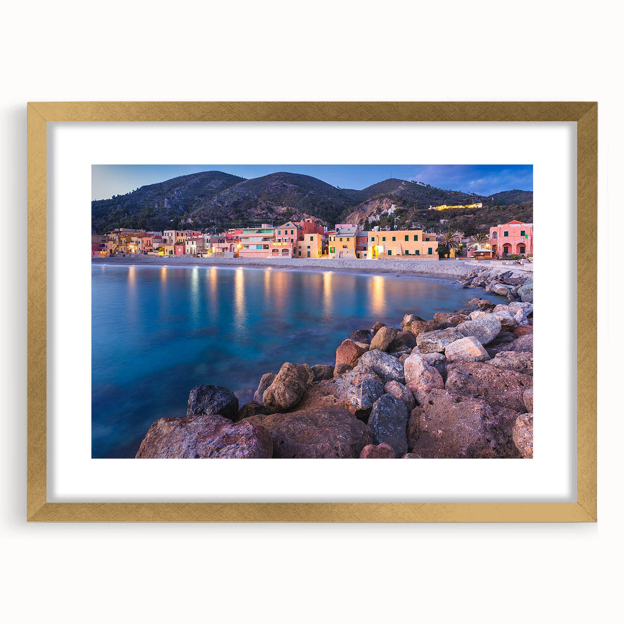 Framed wall art collection showcasing a serene village landscape design with a gold mat, perfect for home decor; emphasizes tranquility and nature.