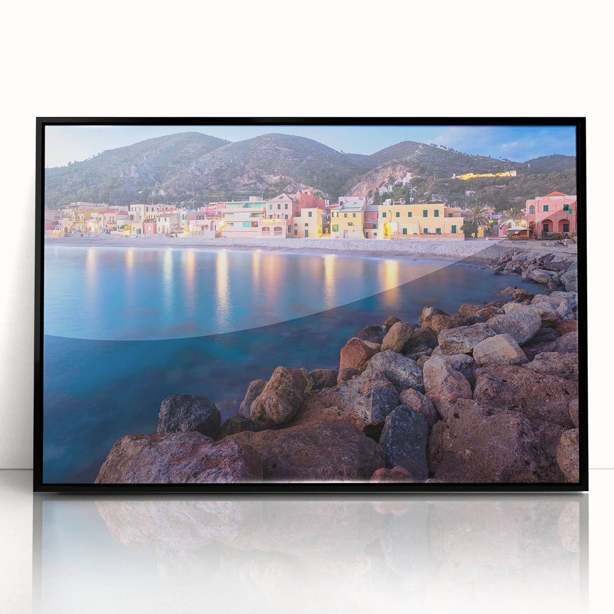 Framed acrylic wall art depicting a serene village landscape, showcasing vibrant colors and intricate details, ideal for home decor settings. The black frame adds elegance and contrast to the artwork, enhancing its visual appeal.