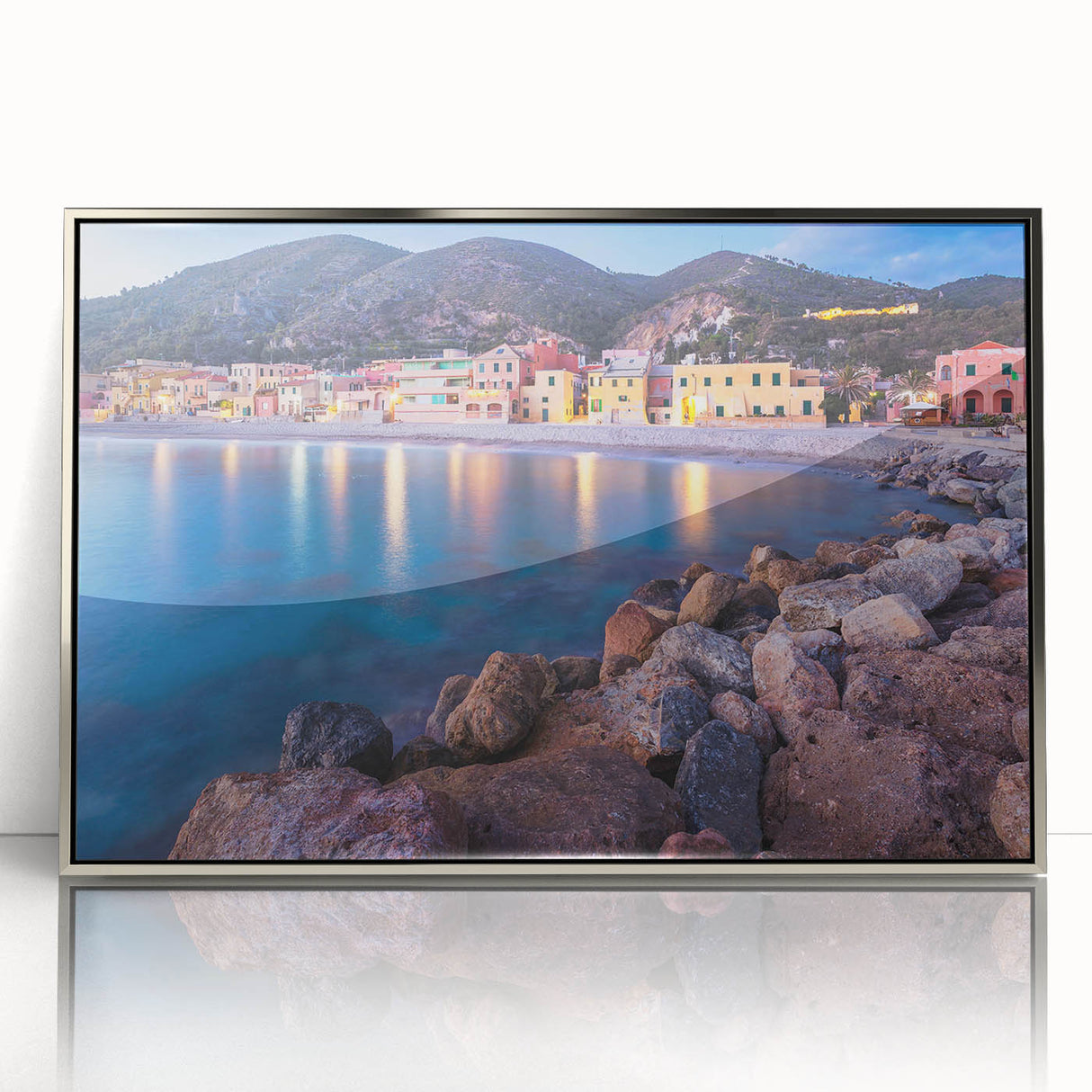Framed wall art featuring a serene landscape village scene, designed with vibrant colors and intricate details, showcased in a sleek silver frame for modern decor.