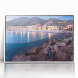 Framed acrylic wall art featuring a serene village landscape design, showcasing lush greenery and quaint houses, presented in a sleek white frame for modern decor.