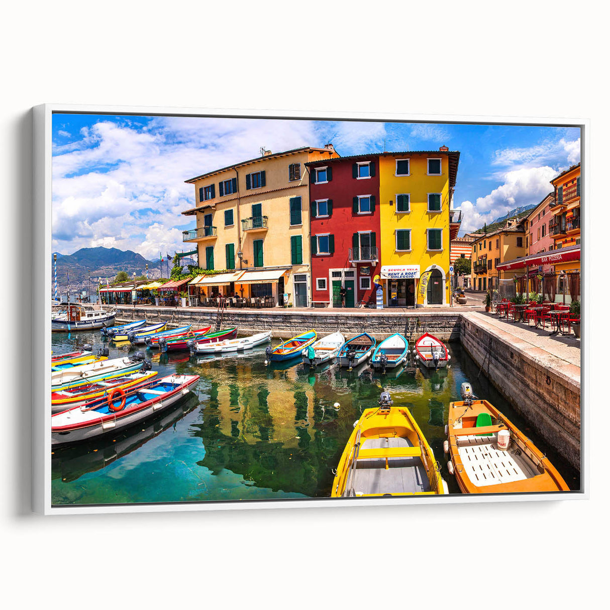 Framed canvas art depicting a serene village landscape with lush greenery and a clear blue sky, showcasing vibrant colors and intricate details, perfect for home decor.