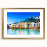 Framed wall art collection showcasing vibrant landscape and village designs, featuring a gold mat and frame, perfect for enhancing home decor.