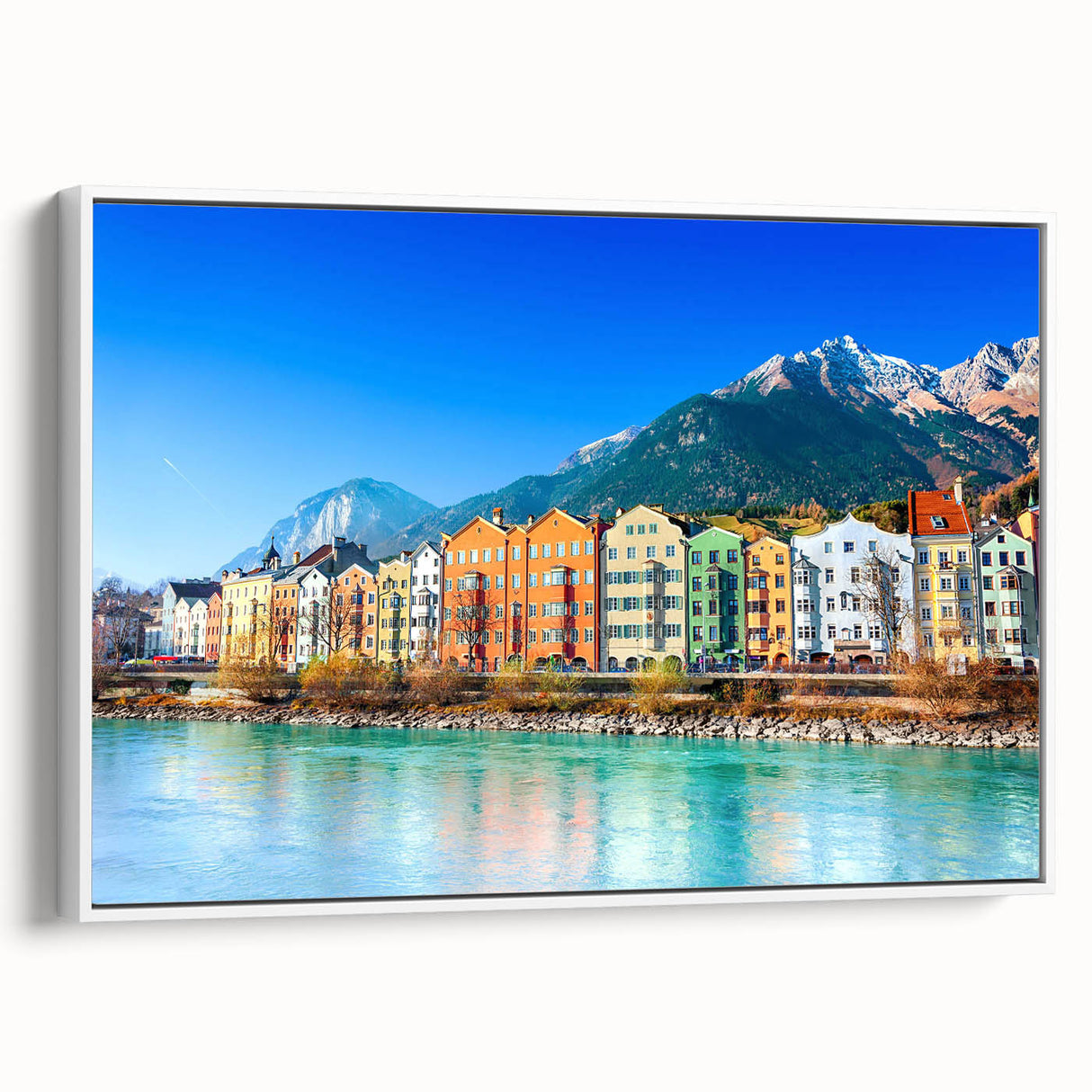 Framed canvas wall art displaying a serene village landscape design with vibrant colors, featuring lush greenery and quaint houses, perfect for home decor.