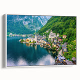 Framed canvas wall art showcasing a serene village landscape with soft colors and intricate details, perfect for home decor, displayed in a white frame with a side view.