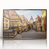 Framed acrylic wall art featuring a vibrant village landscape design with golden accents, perfect for home decor, enhancing any living space with charm.