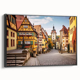 Framed canvas wall art showcasing a detailed landscape village design, featuring vibrant colors and intricate patterns, displayed from a black side view for modern decor.