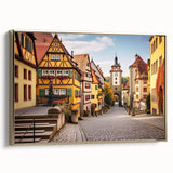Framed canvas wall art showcasing an elegant landscape village design with gold accents, perfect for home decor. The side view highlights its stylish frame and rich colors, enhancing any interior space.