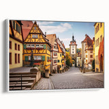 Framed canvas wall art depicting a serene village landscape with vibrant colors, showcasing a white frame and side view, ideal for home decor enthusiasts.