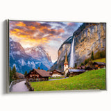 Framed canvas wall art showcasing a serene village landscape with vibrant colors and intricate details, accented by a sleek silver frame, perfect for home decor.