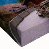 Close-up of a vibrant stretched canvas wall art collection depicting serene landscapes and quaint villages, showcasing rich colors and intricate designs, perfect for home decor.